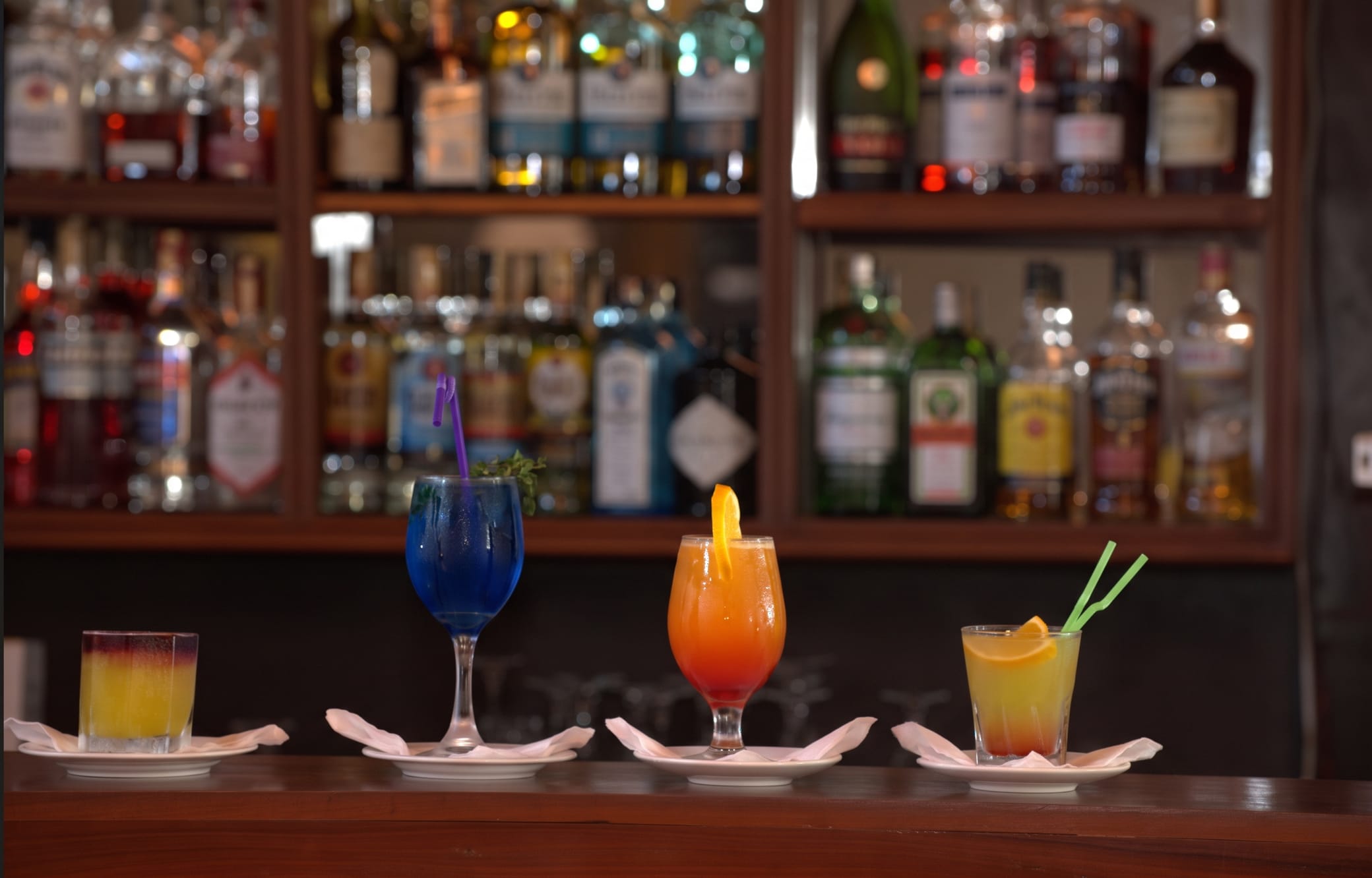 Colourful cocktails lined up on the bar counter