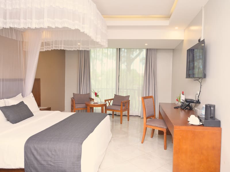 Executive Room with a canopied bed, work desk, sitting area and garden-view windows