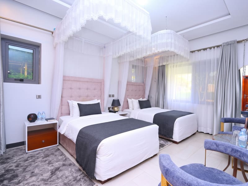 Superior Twin Room with two canopied single beds and velvet lounge chairs